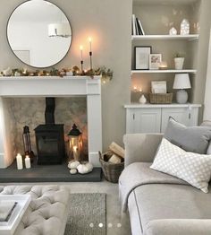 a living room filled with furniture and a fire place next to a mirror on the wall