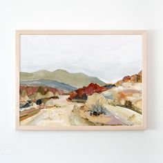 a painting hanging on the wall next to a white wall with a wooden framed frame