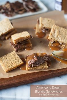 peanut butter and jelly filled desserts on a cutting board with caramel drizzle