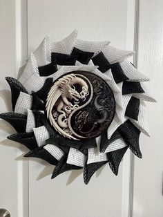 a white door with a black and white dragon decoration on it