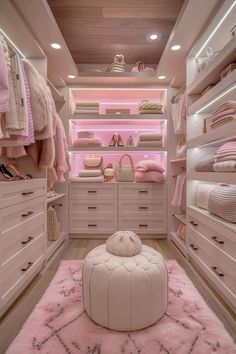 a walk in closet filled with lots of white furniture and pink carpeted flooring