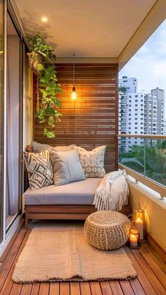 a balcony with wooden flooring and lots of pillows