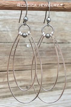 Hammered, elongated silver hoops with a bit of antiqued silver accent and ear wires. #SilverHoopEarrings #SilverJewelry #HoopEarrings #HammeredSilverEarrings #DangleHoopEarrings BohochicSilverJewelry #Giftsforher Soldered Silver Teardrop Earrings, Silver Soldered Teardrop Earrings, Silver Teardrop Soldered Earrings, Silver Small Hoop Teardrop Earrings With Ear Wire, Silver Teardrop Hand-forged Hoop Earrings, Silver Teardrop Hand Forged Hoop Earrings, Hand Forged Teardrop Silver Hoop Earrings, Lotus Flower Jewelry, Jewelry Hoop Earrings