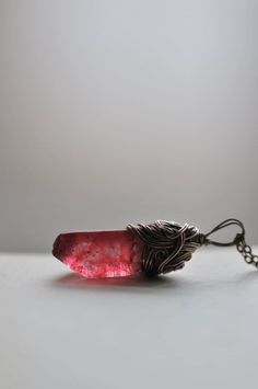 This listing is for an amazing raw crystal necklace in gorgeous red color. I decided to call it Frozen Blood Necklace because of its unusual color. Bohemian and wild! I love working with raw stones. They show real genius of Mother Nature. I really adore their natural, raw look. Their simple, organic beauty. They are so amazing, that I always want to just hang them on the neck. I don't want to add too much since this crystal shines on its own. I dress stones in rustic copper to feature their natural beauty. So here we have, passionate Frozen Blood Crystal Necklace with a wild heart and free soul... material: raw crystal  copper measurements: total chain length:  18 inches (46 cm) or  25" (64 cm) or  just pendant without the chain :) pendant length: 1,37 inches total (3,5 cm)  For latest new Red Hand Wrapped Necklace As Gift, Hand Wrapped Red Necklace As Gift, Red Hand Wrapped Necklace For Gift, Unique Ruby Necklace For Gift, Red Natural Stone Crystal Pendant Necklace, Red Spiritual Crystal Necklace With Natural Stones, Red Gemstone Pendant Crystal Necklaces, Red Gemstone Pendant Crystal Necklace, Red Pendant Crystal Necklaces With Gemstone