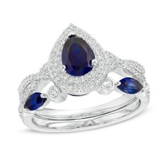 Make a stunning statement of love with this enchanting bridal set. Fashioned in sterling silver, this Art Deco-inspired style showcases a 7.0 x 5.0mm pear-shaped lab-created bright blue sapphire wrapped in a double halo of shimmering lab-created white sapphires. Additional created sapphires gleam along the twist split shank. On your special day, present her with the coordinating wedding band - adorned with alternating 4.5 x 2.0mm marquise-cut created blue sapphires and bezel-set created white sa Sapphire Wedding Ring Set, Center Stone Engagement Ring, Sapphire Halo Ring, Her Ring, Sapphire Wedding Rings, Double Frame, Peoples Jewellers, Double Halo, Split Shank