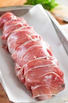 raw meat sitting on top of a cutting board