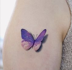 a small purple butterfly tattoo on the left side of the right arm, with watercolors