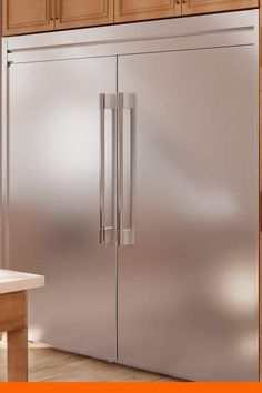 a stainless steel refrigerator in a kitchen with wooden cabinets and white counter tops on an orange background