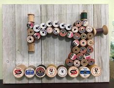 a wooden letter made out of spools of thread