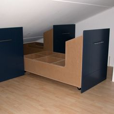 an empty room with some blue cabinets and bookshelves on the floor in front of it