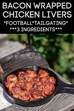 bacon wrapped chicken livers in a cast iron skillet sitting on a picnic table