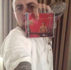 a man holding up a cd in front of his face