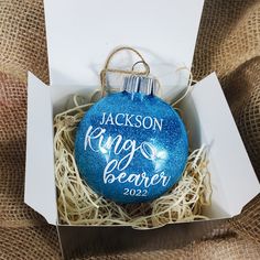 a personalized ornament in a box for someone to put on their christmas tree