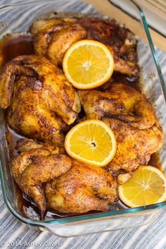 chicken with lemons and sauce in a glass dish