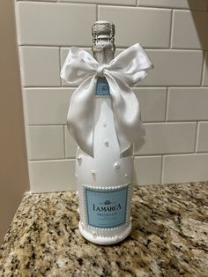 a bottle with a bow on it sitting on a counter