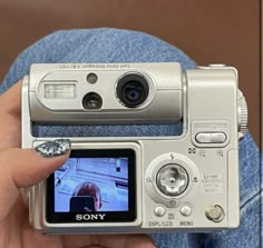 a person holding up a camera with the image on it's screen in their hand