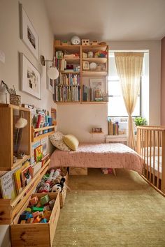 there is a small child's room with bookshelves and toys in it