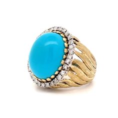 Make a statement with this stunning vintage cocktail ring! Crafted in 14 karat yellow gold, this Mid-Century piece features a richly textured band and an oval cabochon cut turquoise as the centerpiece. At 16.87 carats, the cabochon cut turquoise exudes a captivating blue hue, making it a standout in any crowd. Surrounding the turquoise are thirty-two (32) accenting natural diamonds, each measuring 1.8mm and weighing .025 carats, for a total accent stone weight of .80 carats. The diamonds add a t Luxury Blue Turquoise Gemstone Ring, Luxury Vintage Cabochon Turquoise Ring, Luxury Turquoise Topaz Jewelry, Elegant Collectible Cabochon Turquoise Ring, Elegant Oval Cabochon Turquoise Ring For Formal Events, Elegant Oval Cabochon Turquoise Ring For Formal Occasions, Luxury Turquoise Oval Cabochon Ring, Luxury Oval Turquoise Ring, Elegant Collectible Turquoise Ring