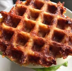 a waffle sandwich on a plate with lettuce