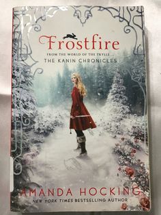 a book cover for frostfire by amanda hocking, with the title in red