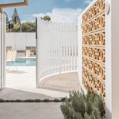 an outdoor area with a pool and white fence