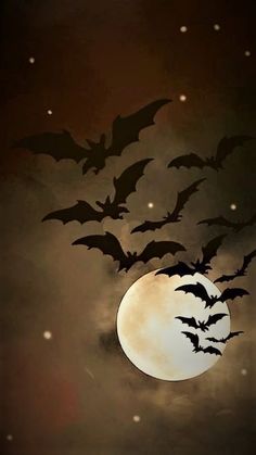 a full moon with bats flying over it