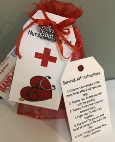 a red cross bag with instructions for survival kit instructions on the front, and an orange ribbon tied around it