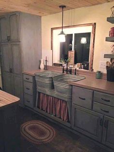 a kitchen with wooden floors and gray cabinets