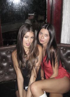 two beautiful young women sitting next to each other