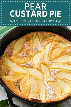 pear custard pie in a cast iron skillet topped with powdered sugar