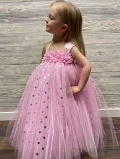 Fuzzy Duckling Design dresses ~ handcrafted for the little princess in your life. Our beautiful dresses feature a stretchy, crocheted bodice that is fully lined for both comfort and modesty. The full skirts sparkle and shine with three layers of high quality tulle in matte, shimmer, and a special silver foil polka dot finish. A floral bodice and satin ribbon straps make this dress something extra special. Our standard dresses are designed to be tea-length and should reach to approximately mid-ca Cute Polka Dot Dress For Birthday, Polka Dot Princess Dress For Party, Princess Style Polka Dot Party Dress, Princess Dress For Birthday And Easter, Princess Birthday Dress For Easter, Cute Sleeveless Fairy Dress For Birthday, Easter Princess Birthday Dress, Pink Princess Dress For Birthday And Easter, Princess Style Fairy Dress For First Birthday