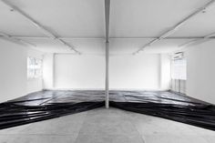 an empty room with black tarp covering the floor