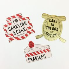 three stickers that say i'm carrying a cake in the box and fragile