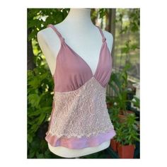 "Approx flat lay measurements Chest 16\" Length 23.5\" Size small on tag. 100% polyester. Made in China. Stunning satin camisole in a dusty rose colour way. A lace panel decorates across the abdomen, v neckline, straps feature a twisted knot design. No closures, it is pull on. No holes, tears or stains, pet snd smoke free home." Pink V-neck Top With Adjustable Straps, Pink Fitted Lace Top Camisole, Fitted Lace Top Pink Camisole, Fitted Pink Camisole With Lace Top, Pink Camisole With Spaghetti Straps, Pink Spaghetti Strap Camisole Bra Friendly, Pink Lace Top Camisole, Pink Feminine Bra Friendly Top, Feminine Pink Bra-friendly Tops