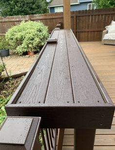 a wooden bench sitting on top of a wooden deck