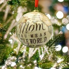 an ornament hanging from a christmas tree that says mom you mean the world