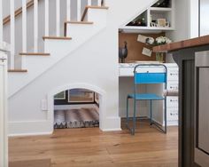 a blue chair sitting under a stair case