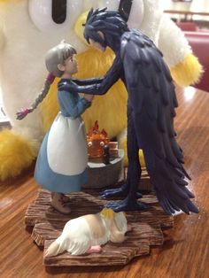 there is a figurine that looks like a woman and a bird on the table