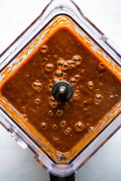 an overhead view of a food processor with sauce in it