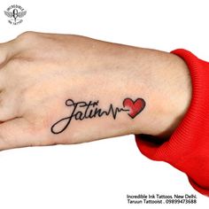 a woman's wrist tattoo with the word faith and a heart in cursive writing