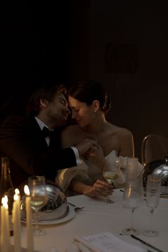 a man and woman sitting at a dinner table