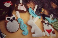 several stuffed animals sitting on top of a wooden table next to scissors and other items