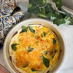 an omelet with spinach and cheese in a bowl