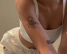 a woman with a scorpion tattoo on her arm