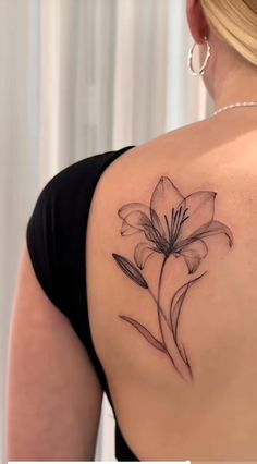 a woman with a flower tattoo on her shoulder