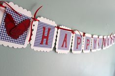 a red, white and blue happy birthday banner hanging from the side of a wall