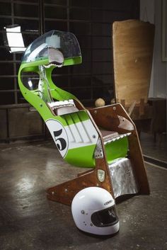 a green and white chair with a helmet on it