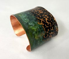 These unique, hand-formed copper and brass cuff bracelets with vibrant patinas create stunning accents to your personal style. Dress up or down- either way you'll be wearing an adornment that will turn heads, start conversations, and delight the eye of the beholder. This is a wide, hammered copper cuff with antique and green patinas. Colors look slightly different depending on the device you view the product on. This is a small size cuff, see measurements below. Cuffs have a 1” gap. Use a fabric Bohemian Electroformed Cuff Bracelet Bangle, Bronze Wearable Art Cuff Bracelet As Gift, Artisan Copper Bangle Cuff Bracelet, Artisan Copper Cuff Bangle Bracelet, Artisan Electroformed Cuff Bangle Bracelet, Artistic Patina Cuff Bracelet As Gift, Artistic Patina Cuff Bracelet Gift, Artisan Green Cuff Bangle Bracelet, Unique Green Cuff Bracelet Bangle