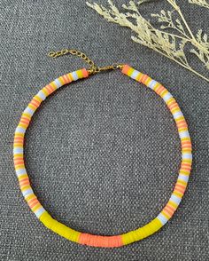 This necklace is handmade to last, with a nice colorful pattern, perfect for the summer (or any time of the year, really)! This choker necklace gives bohemian-style vibes to your look. Each boho-style necklace was created with 6 mm clay polymer discs, stainless steel-look lobster clasp, and 2 inch extender chain. I'm offering this necklace in seven different lengths. If you are interested in a different length or colors, please message me! My business thrives on Customer Satisfaction Please do not hesitate to reach me in case there is something wrong with your purchase. I will try my best to make it right for you. Thank you for shopping JGBestBeadedJewelry! Handmade Yellow Heishi Beads Jewelry, Handmade Orange Beaded Casual Necklace, Yellow Letter Beads Jewelry For Festival, Handmade Orange Heishi Beads Jewelry, Casual Orange Necklaces For The Beach, Casual Handmade Orange Necklace, Polymer Necklace, Boho Style Necklaces, Surfer Necklace