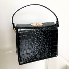 *Never Worn**Excellent Condition* A Faux Crocodile Leather Crossbody Bag Featuring A Small Structured Body, High-Polish Curb Chain Shoulder Strap, Top Handle, And A Flap Top With A Twist-Lock Closure. Strap And Be Tucked Inside Bag. - Shell & Other Contents: 100% Polyurethane - Height: 5" - Width: 6" - Depth: 2.5" Black Mini Purse, Forever 21 Bags, Inside Bag, Crocodile Leather, Strap Top, Mini Purse, Curb Chain, Black Mini, Leather Crossbody Bag